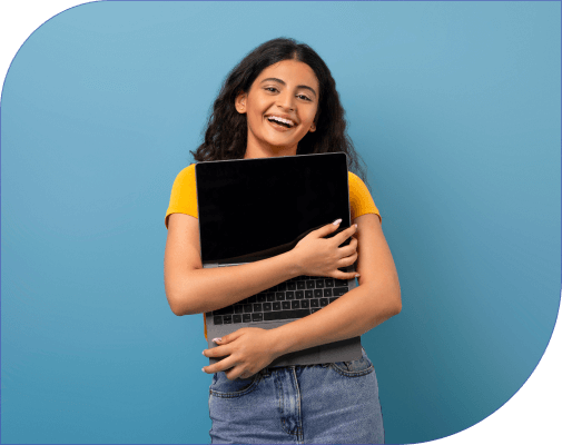 Delighted young girl smiles while holding a laptop.