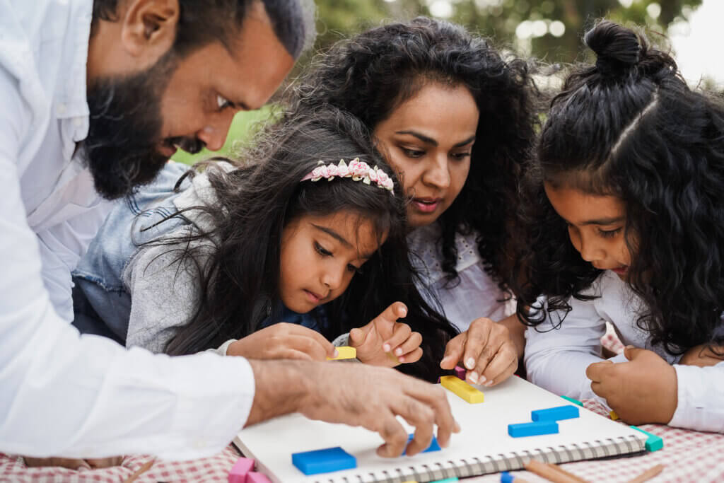 Happy indian family doing an activity outdoors.