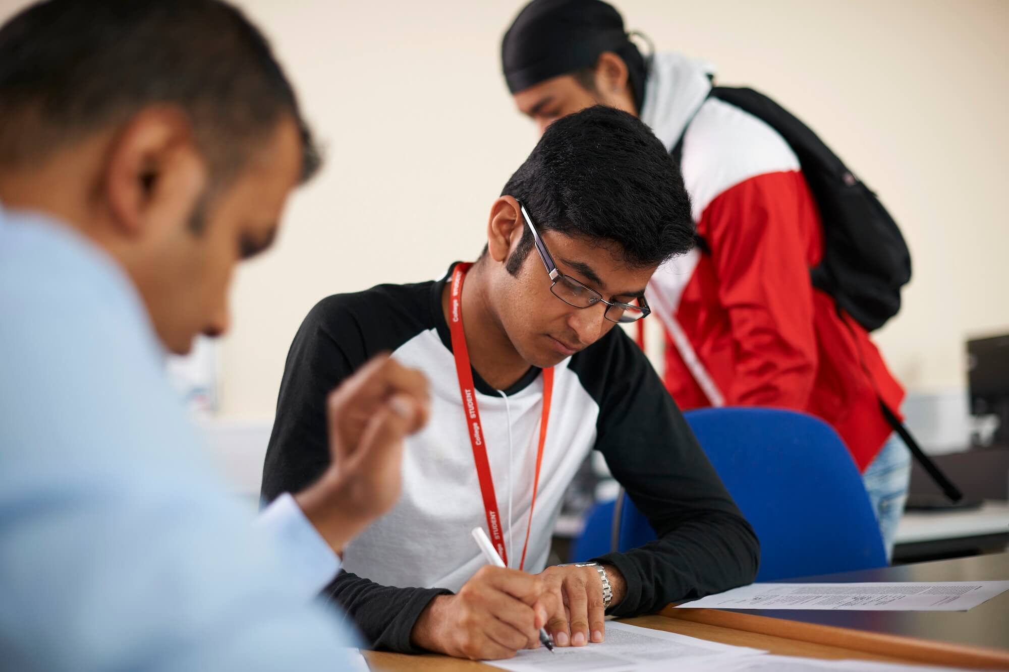 Lecturer talking to college students in classroom