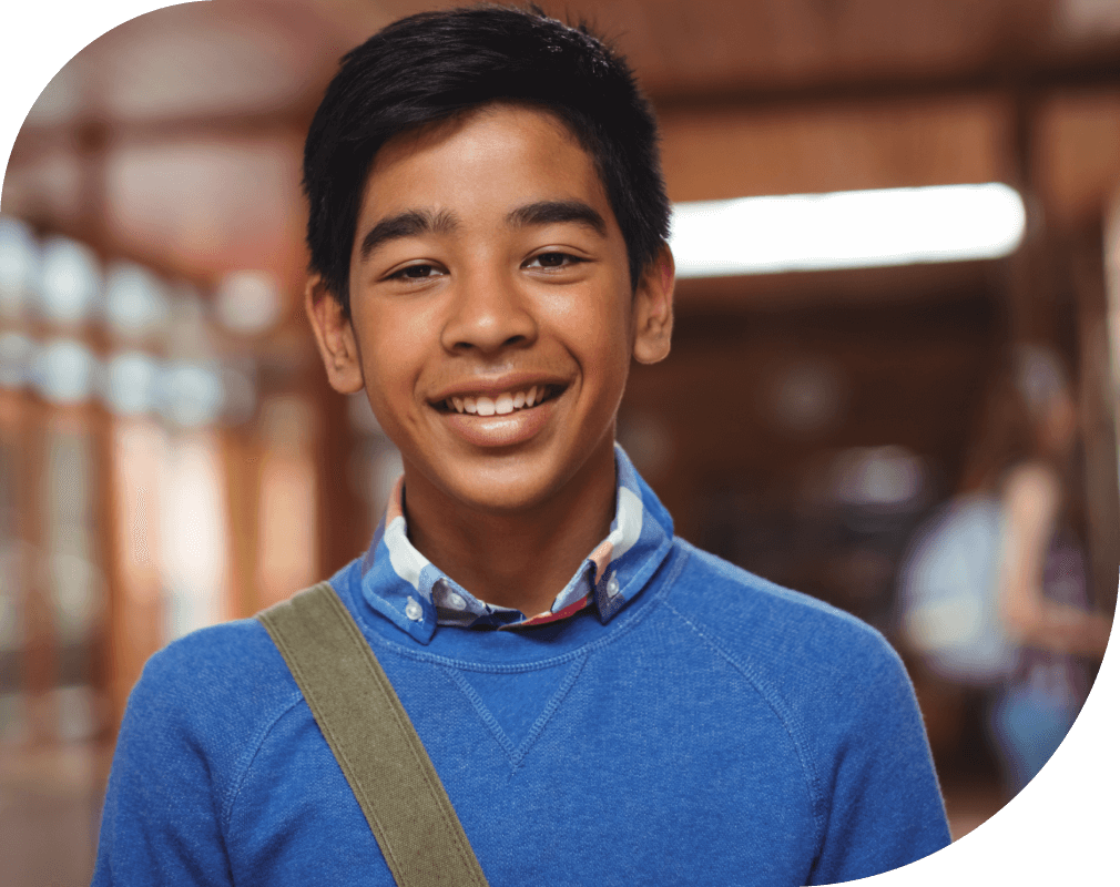 Young smiling boy in blue sweater.