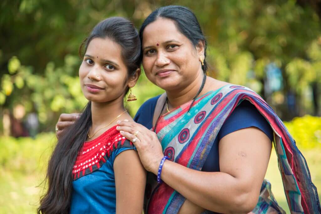 Portrait of happy mother and daughter embracing, Smiley mother and daughter at outdoor.